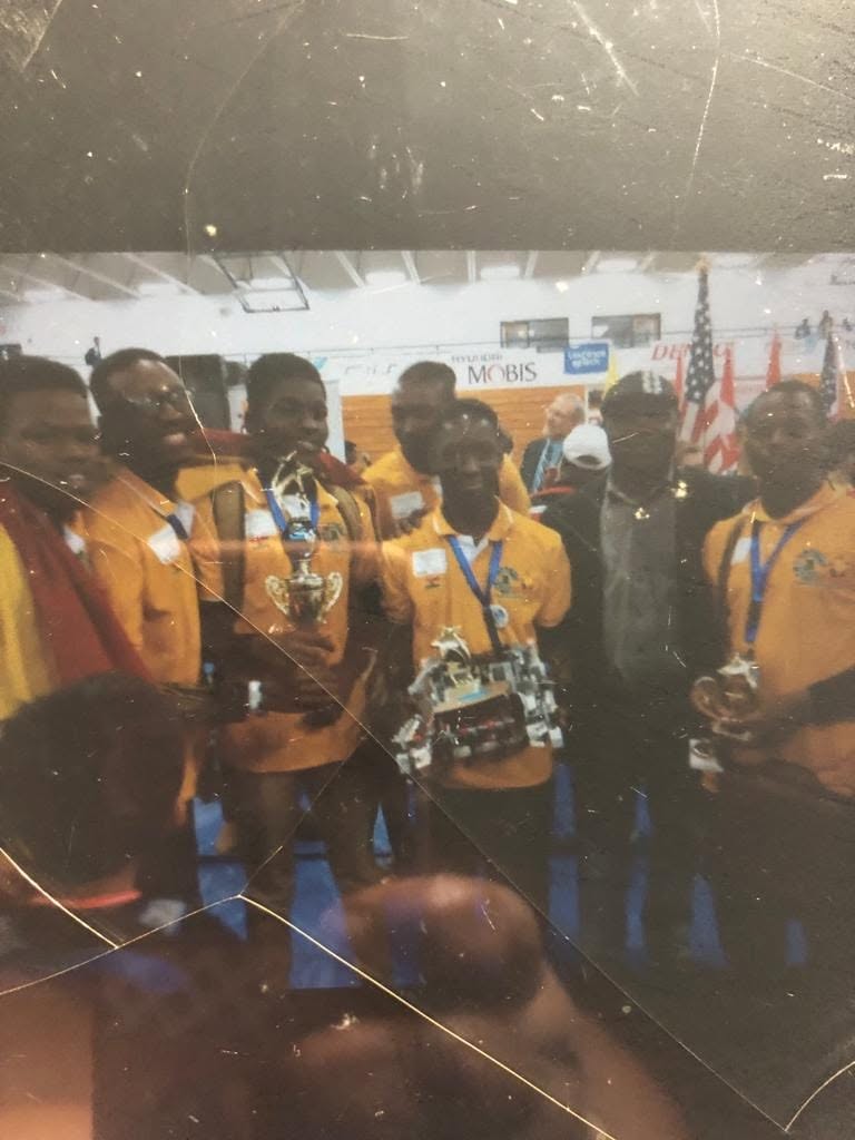 Nathaniel holding his award trophy